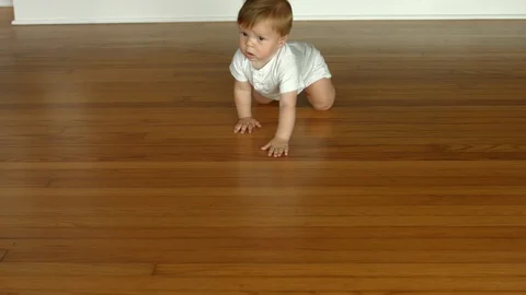 4K slow motion shot of a cute baby boy crawling toward the camera Stock Footage 121636738
