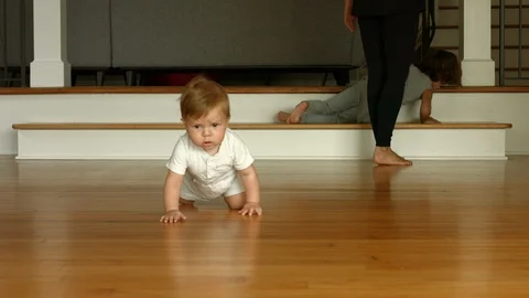 4K slow motion shot of a cute baby boy crawling toward the camera Stock Footage 121636841