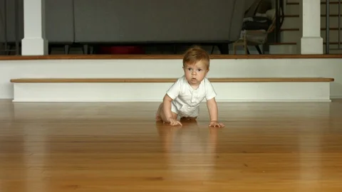 4K slow motion shot of a cute baby boy crawling toward the camera Stock Footage 121637837