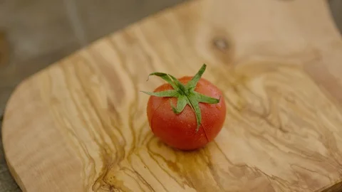 4K Slow Motion Shot of Cutting Tomato with Kitchen Knife Stock Footage 121829696