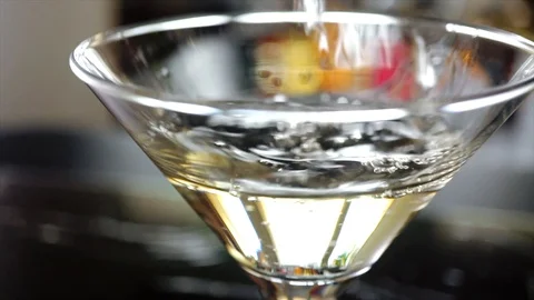 4k, Slow motion shot of olive splashing into martini Stock Footage 113514185