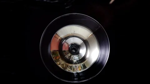 4k, Slow motion shot of olive splashing into martini, top view Stock Footage 113514246
