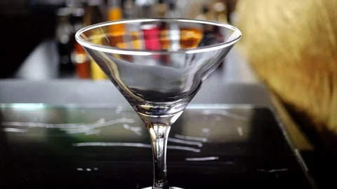 4k, Slow motion shot of olive splashing into martini Stock Footage 113514271