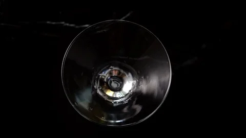 4k, Slow motion shot of olive splashing into martini, top view Stock Footage 113514306