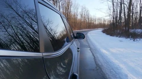 4K Slow Motion Side Shot of a Car Driving Through Snowy Winter Roads Stock Footage 300148237
