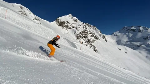 4K slow motion ski video woman skiing in short turns on slope Stock Footage 124611392