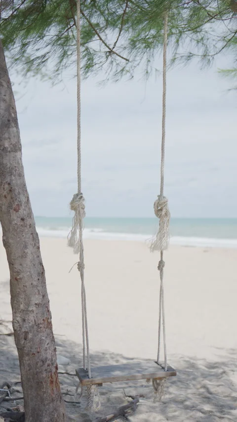 4K Slow motion a swing on the beach Stock Footage 337174200