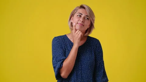 4k slow motion video of blank emotion of one woman on yellow background. Stock Footage 227752435