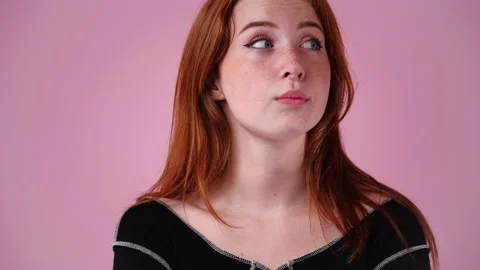 4k slow motion video of blank emotion of one girl on pink background. Stock Footage 228721774