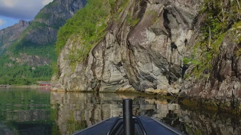 In a 4K slow-motion video, the bow of a boat frames a serene scene. Stock Footage 253436306