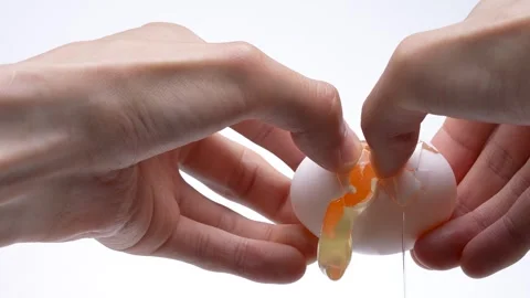 4K slow motion video of breaking an egg. Stock Footage 320923228