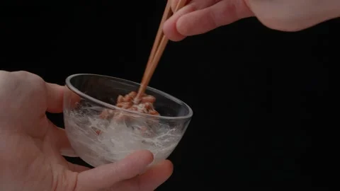 4K slow motion video to check the stickiness of natto. Stock Footage 235500560