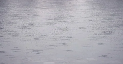 4K slow motion video close up rain drop in the water pool. Background for rel Stock Footage 212073846