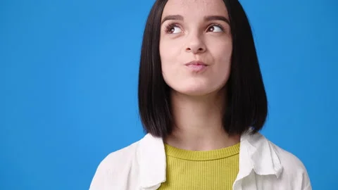 4k slow motion video of cute girl thinking about something over blue background. Stock Footage 226690495