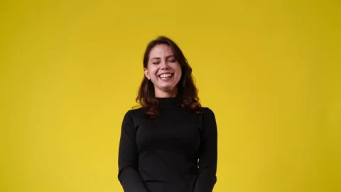 4k slow motion video of cute woman smiling over yellow background. Stock Footage 227747056