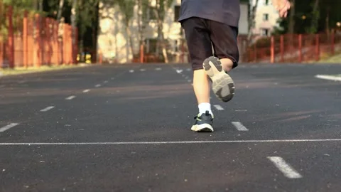4K Slow motion video of a cute little boy running on a sports stadium track. 库存影片 341682470