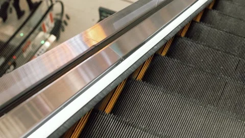 4K Slow motion video of empty moving escalator stairs. Close up top view shot Stock Footage 341958409