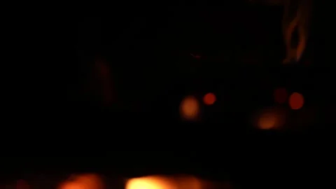 A 4K slow motion video of logs burning with orange flames at a braai Stock Footage 260116030