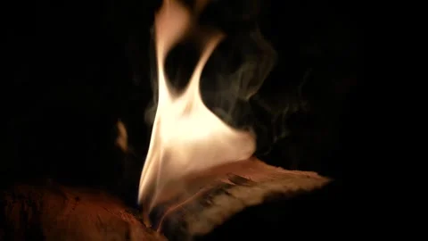 A 4K slow motion video of logs burning with orange flames at a braai Stock Footage 260116033