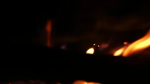 A 4K slow motion video of logs burning with orange flames at a braai Stock Footage 260116041