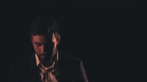 4k slow motion video of a man wearing black suit on black background. Stock Footage 169638749