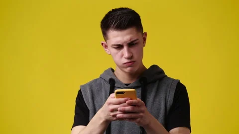 4k slow motion video of one man using phone over yellow background. Stock Footage 226689273