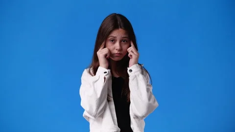 4k slow motion video of one girl having headache over blue background. Stock Footage 226700242