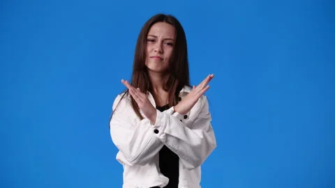4k slow motion video of one girl with crossed hands on blue background. Stock Footage 227218195