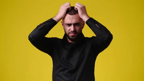 4k slow motion video of one man in panic on yellow background. Stock Footage 227404919