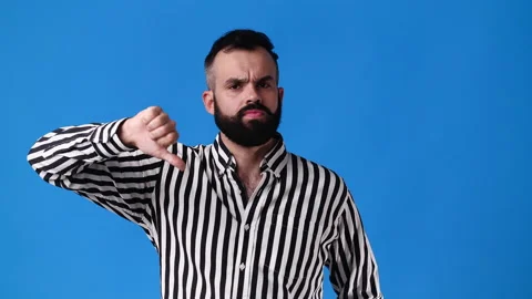 4k slow motion video of one man showing thumb down on blue background. Video stock 227422919