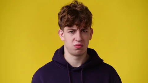 4k slow motion video of one man with negative facial expression on yellow Stock Footage 227427629