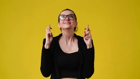 4k slow motion video of one woman wishing something on yellow background. Stock Footage 227512443