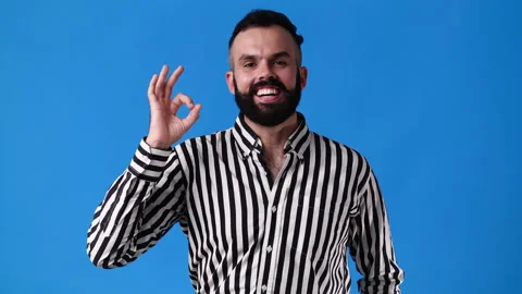 4k slow motion video of one man showing OK sign on blue background. Stock Footage 227737713