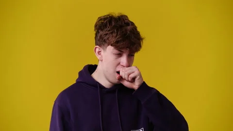 4k slow motion video of one man yawning over yellow background. Stock Footage 227739824