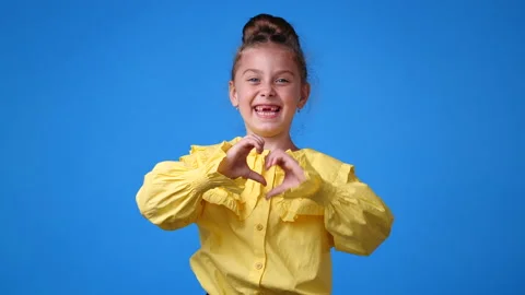 4k slow motion video of one girl showing thumb up over blue background. Stock Footage 227751471