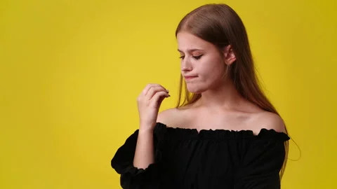 4k slow motion video of one girl in panic on yellow background. Stock Footage 228686305