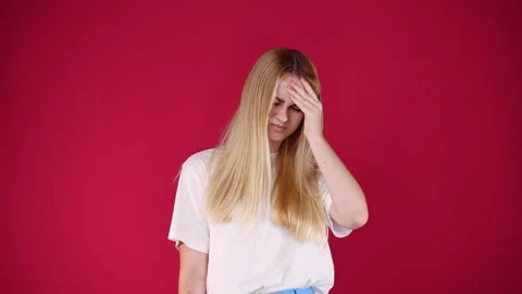 4k slow motion video of one girl touching her forehead on pink background. Stock Footage 228718470