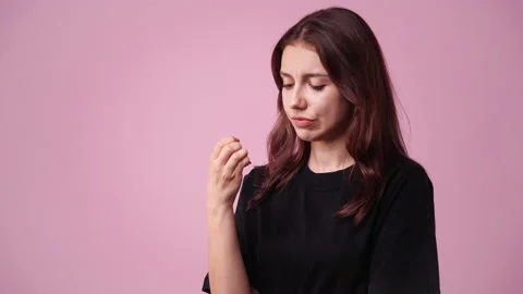 4k slow motion video of one girl in panic on pink background. Video stock 228779260
