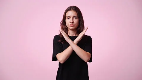 4k slow motion video of one girl with crossed hands on pink background. Stock Footage 229107148