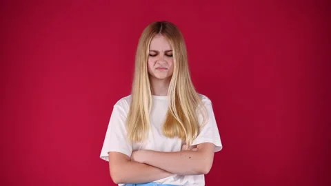 4k slow motion video of one girl with negative facial expression over pink Stock Footage 229111944
