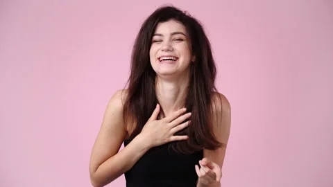 4k slow motion video of one girl laughing over pink background. Stock Footage 229141423