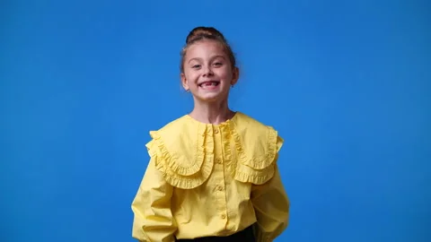 4k slow motion video of one girl posing for a video over blue background. Stock Footage 229661293