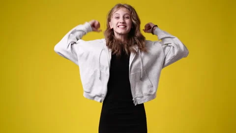 4k slow motion video of one girl is so excited over yellow background. Stock Footage 229676629