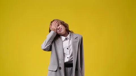 4k slow motion video of one girl with negative facial expression over yellow Stock Footage 229680577