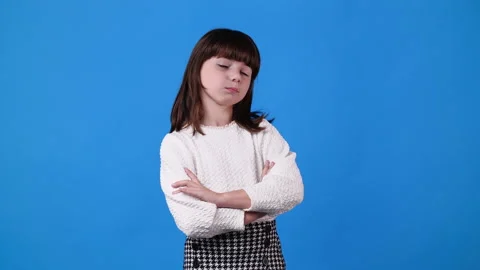 4k slow motion video of one girl with negative facial expression over blue Video stock 229697797