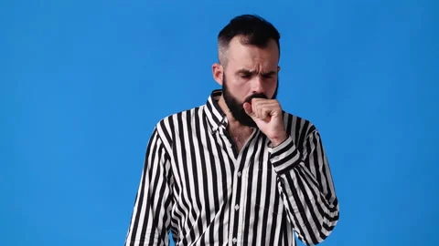 4k slow motion video of one man having headache over blue background. Stock Footage 229970810