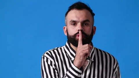 4k slow motion video of one man showing silence sign over blue background. Stock Footage 229973605