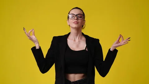 4k slow motion video of one girl meditating on yellow background. Video stock 229977593