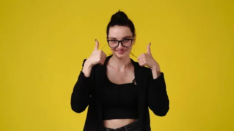 4k slow motion video of one girl pointing at camera and showing thumb up over Stock Footage 229982570