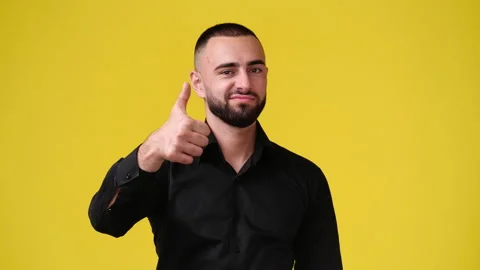 4k slow motion video of one man pointing at the camera and showing thumb up on Stock Footage 229986735